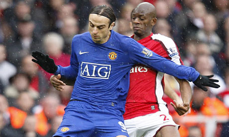 Dimitar Berbatov and Vassiriki Diaby battle for possession at the Emirates Stadium